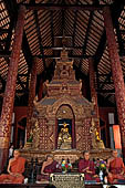 Chiang Mai - The Wat Phra Singh temple. The ubosot (ordination hall). Detail of the ku, a large ornate Buddha throne that sits in the middle of the building. 